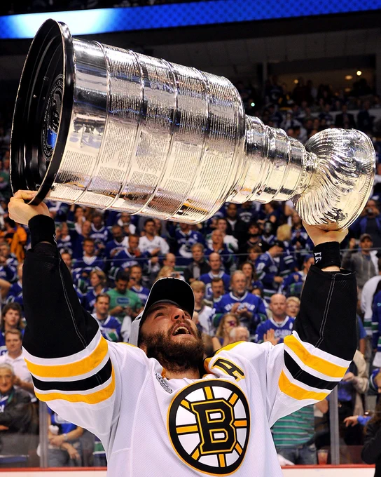 Patrice Bergeron hoisting the Stanley Cup. 